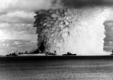 USS Saratoga. Public domain, https://commons.wikimedia.org/wiki/File:USS_Saratoga_(CV-3)_and_other_ships_are_hit_by_Crossroads_Baker_nuclear_blast,_25_July_1946.jpg